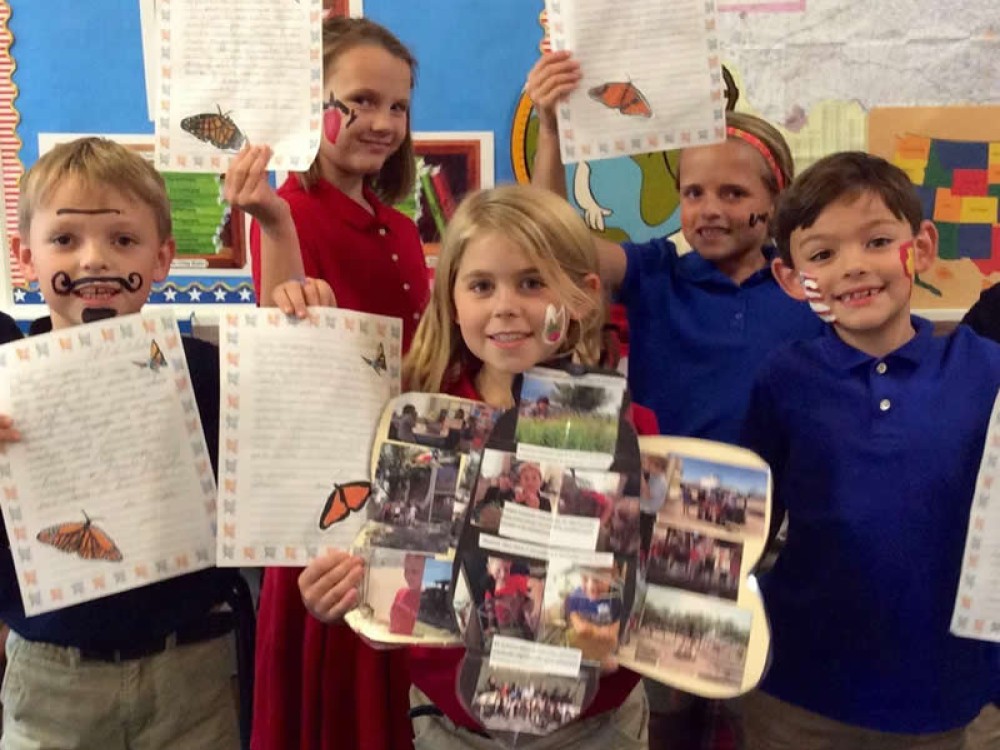 Photo of students with their symbolic butterflies