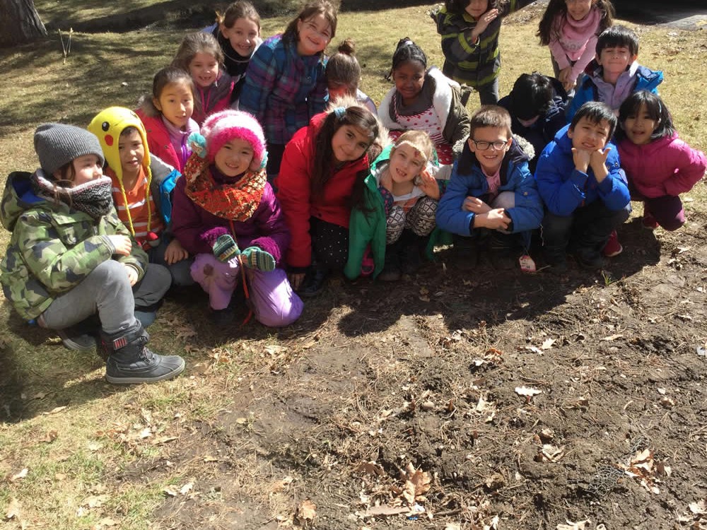 Photo of children in the garden in winter coats