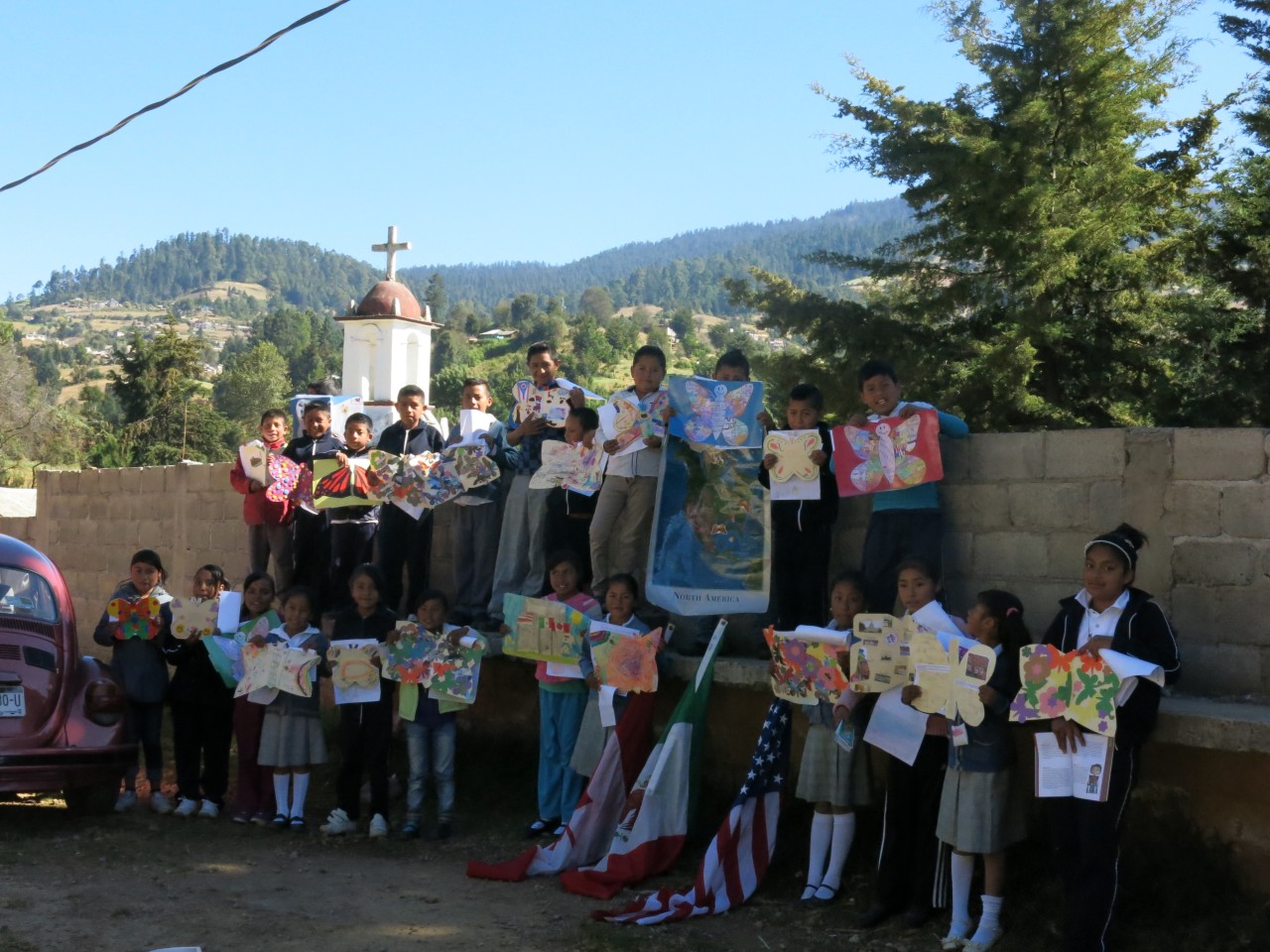 Each student opens their Symbolic Monarch with great excitement and enjoys showing it off during the whole class photograph.