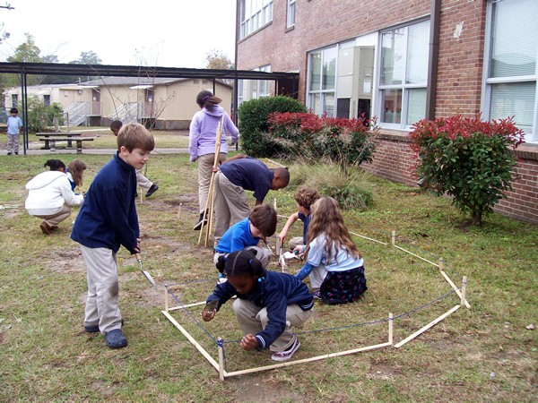 Photo of students staking out garden edges